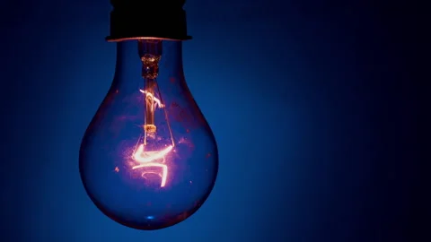 Light Bulb Flashes on a Blue Background in the Dark Stock Footage 236931704