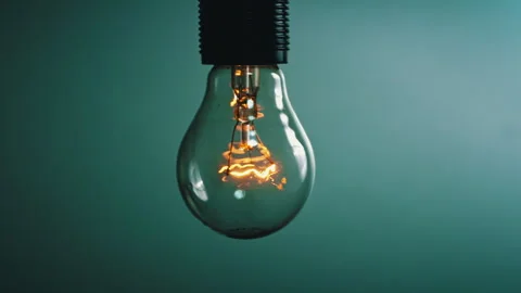 Light Bulb Flashes on a Blue Background in the Dark Stock Footage 261583116