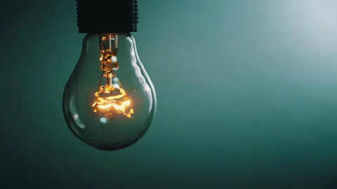 Light Bulb Flashes on a Blue Background in the Dark Stock Footage 263230673