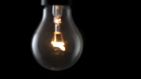 Light bulb flickering and swinging. 4k Black background Stock Footage 89648761