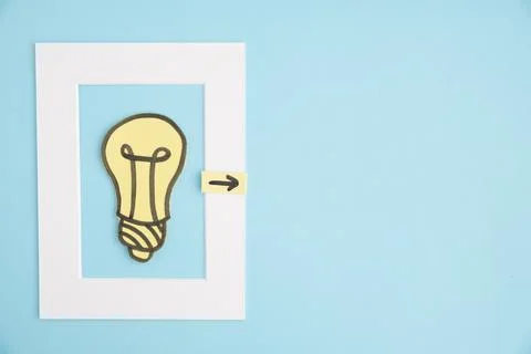 Light bulb frame with directional arrow blue background 스톡 사진