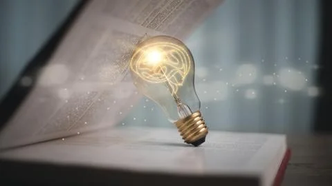 Light bulb glowing on book, idea of ??inspiration from reading, innovation .. Stock Photos