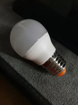 Light bulb on a gray background close-up Stock Photos