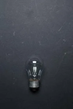 Light bulb on gray background, top view. Creative Idea Concept Stock Photos
