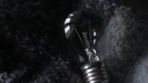 Light Bulb On a gray knitted background Stock Photos