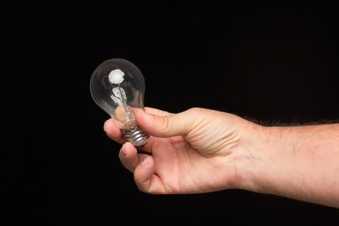 Light bulb in hand on a black background Foto stock