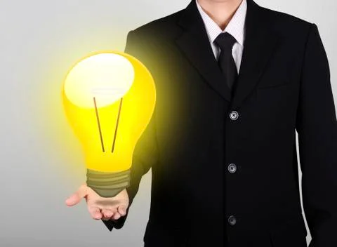 Light bulb on hand businessman Stock Photos
