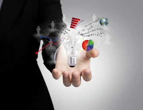 Light bulb in hand with graph out Stock Photos