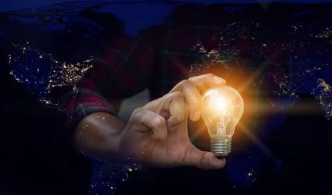 Light bulb in hand, Idea concepts. Man hand holding light bulb blurred back.. Stock Photos