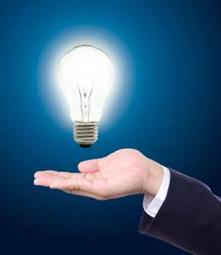 Light bulb in hand Stock Photos