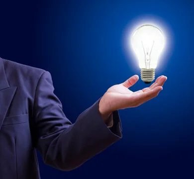 Light bulb on hand Stock Photos