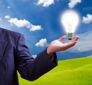 Light bulb on hand Stock Photos