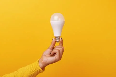 Light bulb in hand Stock Photos