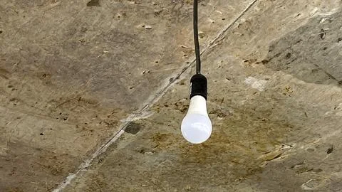 A light bulb hanging from the ceiling Stock Photos