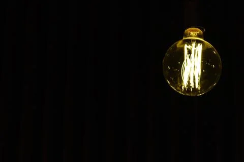 Light bulb hanging on the ceiling with whitespace Stock Photos