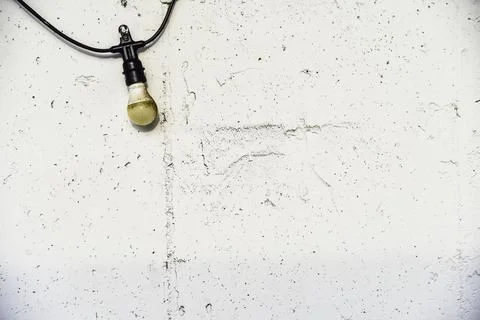 A light bulb is hanging from a chain Stock Photos