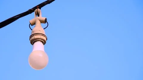 A light bulb hanging from a wire Stock Photos