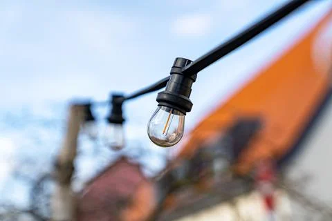 A light bulb is hanging from a wire Stock Photos
