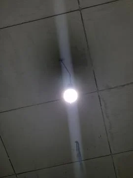 A light bulb hangs from the ceiling Foto stock