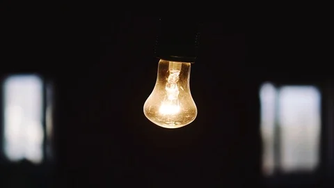 Light Bulb Isolated On Black Background and two white windows Stock Footage 102228558