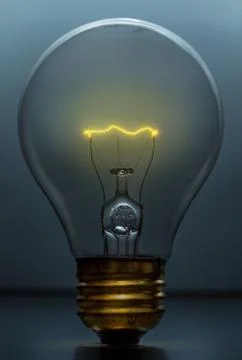 Light bulb Lit on Blue Background 库存照片