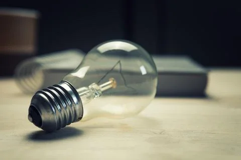 The light bulb is lying on the table Stock Photos