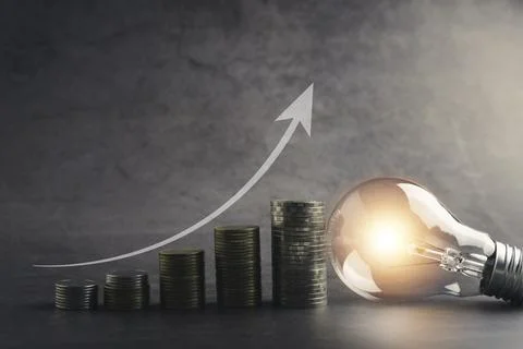 A light bulb with money coin stack growing for business. financial and accoun Foto stock