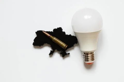A light bulb next to a black 3D outline of a map of Ukraine and a bullet on.. Stock Photos