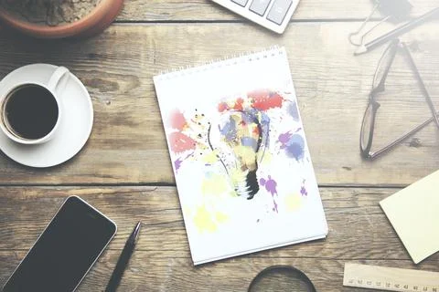 Light bulb  on notebook Stock Photos