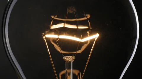 Light bulb over black background. 4K, UHD Stock-Footage 56695516