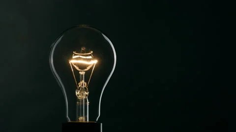 Light bulb over black background. Turning on and turning off Stock-Footage 65815988