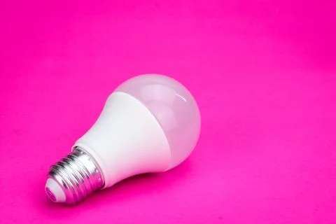 Light bulb on pink background Stock Photos