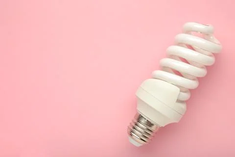 Light bulb on pink background. Space for text Stock Photos