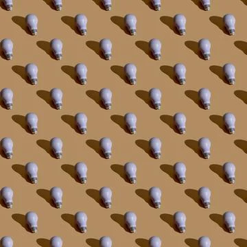 Light bulb seamless pattern. Made in a flat style on a orange background Stock Illustration