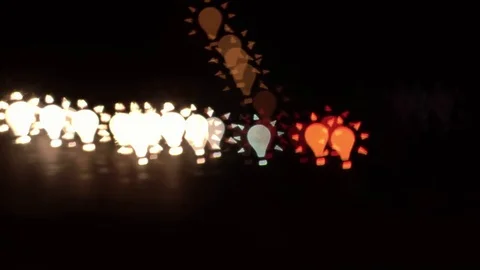 Light bulb shaped bokeh of car lights at night. Stock Footage 80959376