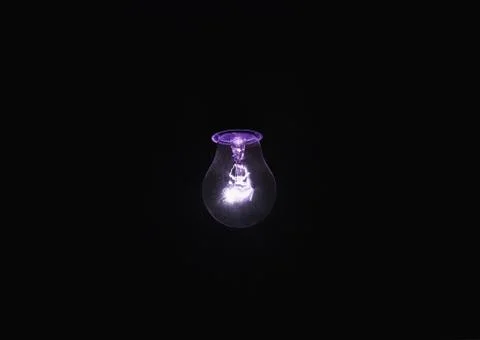 Light bulb shines a bright light, soft focus Stock Photos