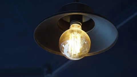 Light bulb shines brightly in a cafe setting Stock Footage 336160158