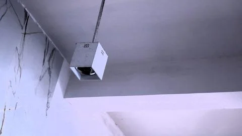 Light bulb with simple rectangle box hanging on the roof Stock Photos