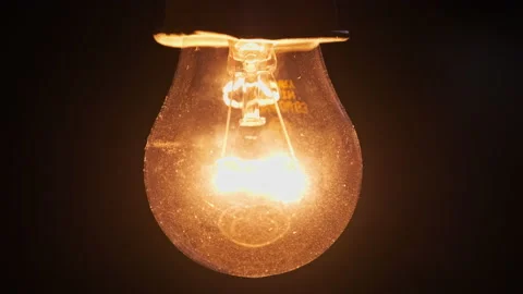 Light Bulb Slowly Turned On and Off on Black Background Stock Footage 175934389