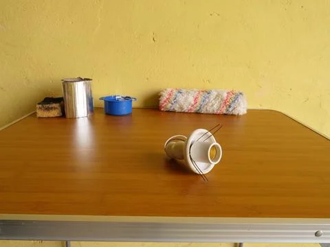 Light bulb socket with spring clips placed on table with painting tools Stock Photos