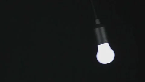 Light bulb staggers on a black background Stock Footage 186083203