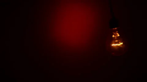 Light Bulb Staggers on a Red Background in the Dark Stock Footage 236740441