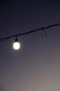 A light bulb with a sunset background on the beach Stock Photos
