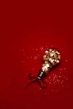 Light bulb with sweets inside. Stock Photos