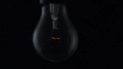 Light bulb swinging and flickering. Slow motion. Video stock 72607527