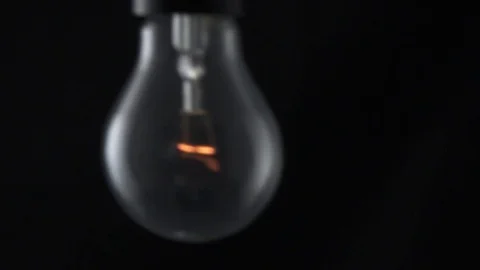 Light bulb swinging and flickering. Slow motion. Stock Footage 72607605