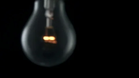 Light bulb swinging and flickering. Slow motion. Stock Footage 72607639