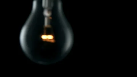 Light bulb swinging and flickering. 4k Stock Footage 89648849