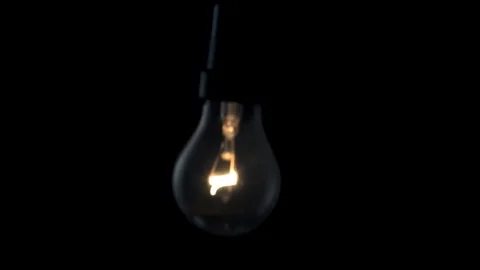 Light bulb swinging to camera. 4k Black background Stock Footage 89648939