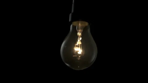 Light bulb swinging to camera and turning on. 4k Stock Footage 89648916